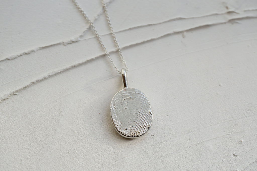 Fingerprint necklace from an ink imprint