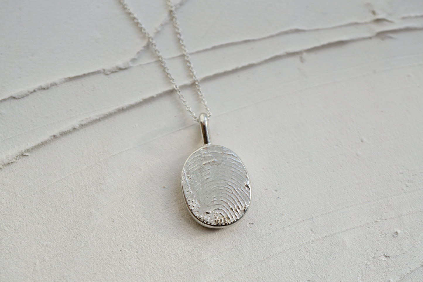 Fingerprint necklace from an ink imprint