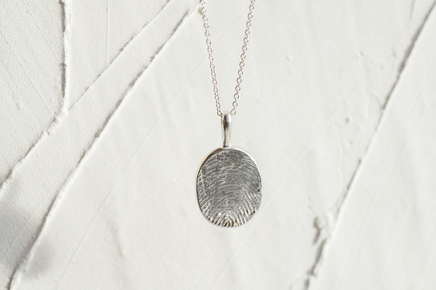 Fingerprint necklace from an ink imprint